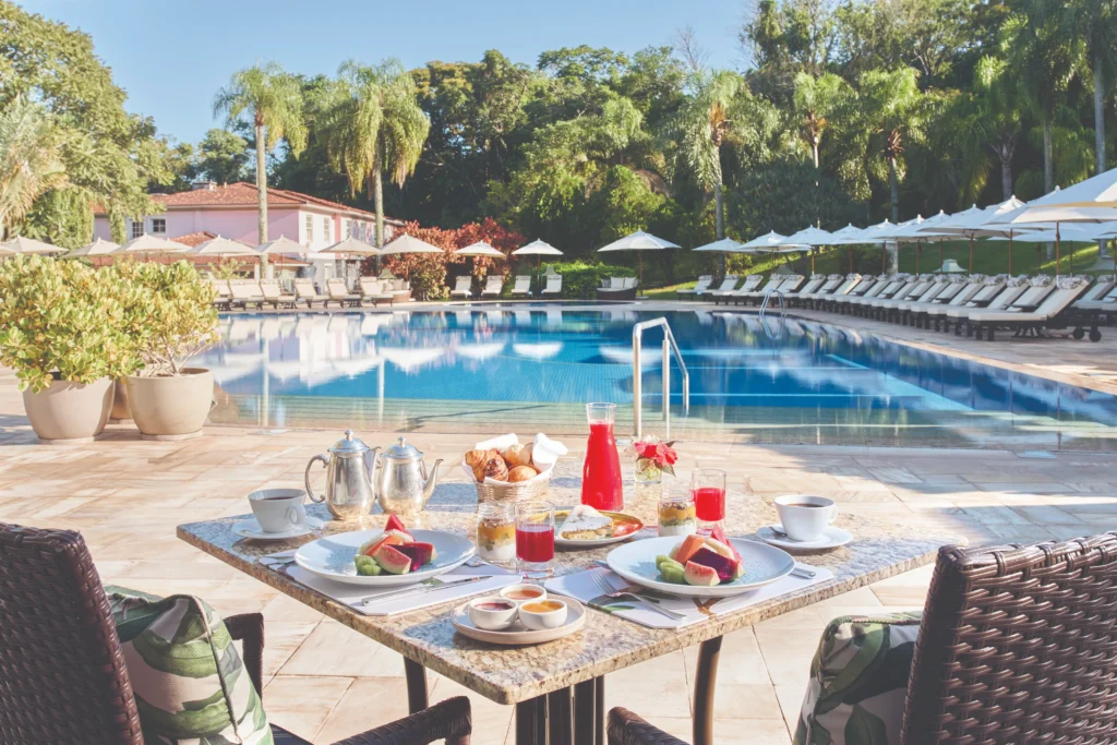 Breakfast table overlooking the swimming pool at Hotel das Cataratas in Foz do Iguaçu, Brazil